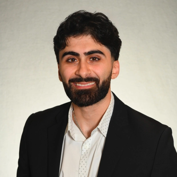 Dr. Asfour, dentist at New Port Richey dental practice, smiling in professional portrait.